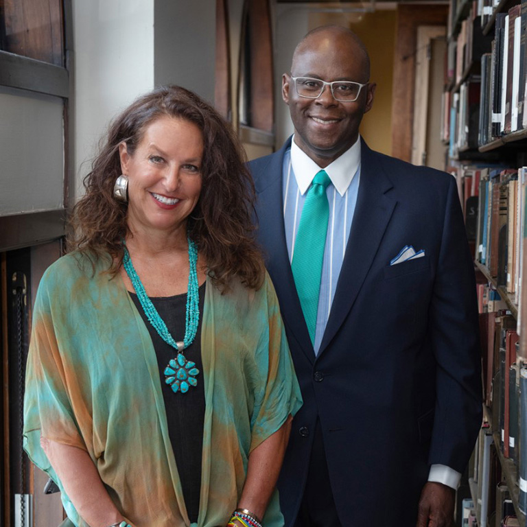 Jennifer Mooney stands next to Byron McCauley in a bookstore, both smiling