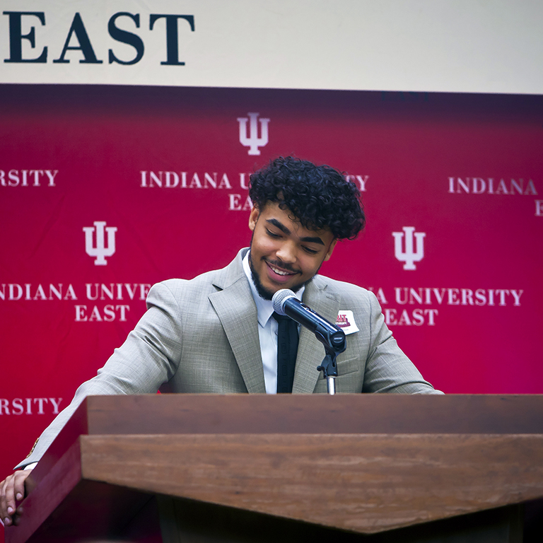 Vincent Narcisse smiling from behind the podium
