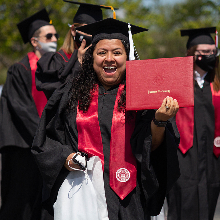IU East Graduates in their cap, gown, and stoles, celebrating at the Commencement Ceremony