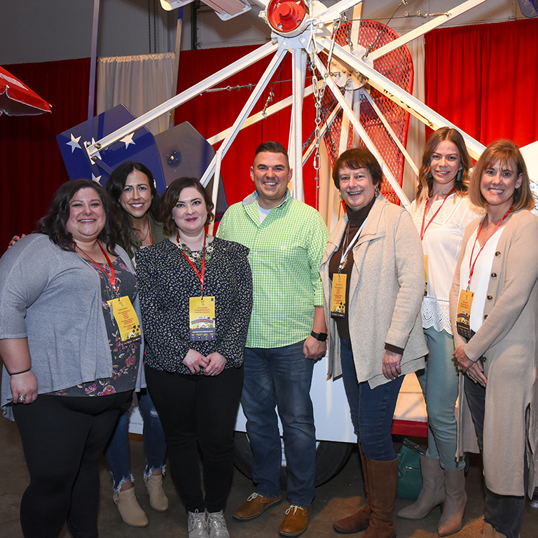 From left to right: Kim Crager, Katie Alyea, Mary Moore, Casey Mitchell, Robin Henry, Heather Closson and Susan Cappa standing together