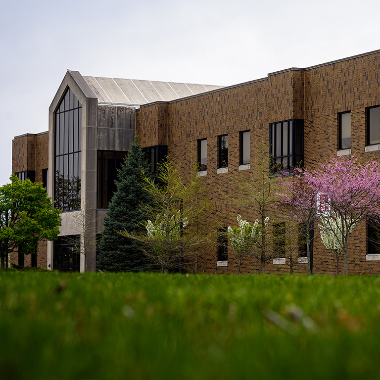 Hayes Hall at the IU East campus on an overcast day, surround by a fresh lawn and trees