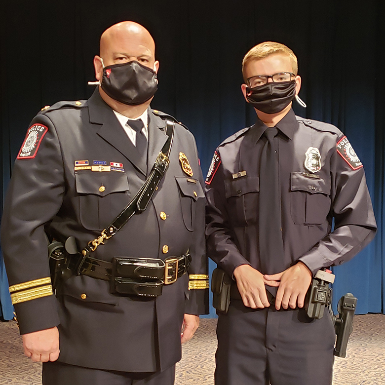 IUPD-East Chief Scott Dunning standing next to Cadet Dylin Lakes in uniform and wearing protective masks