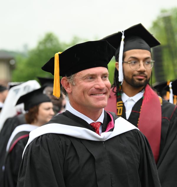 Two men in graduation cap and gown