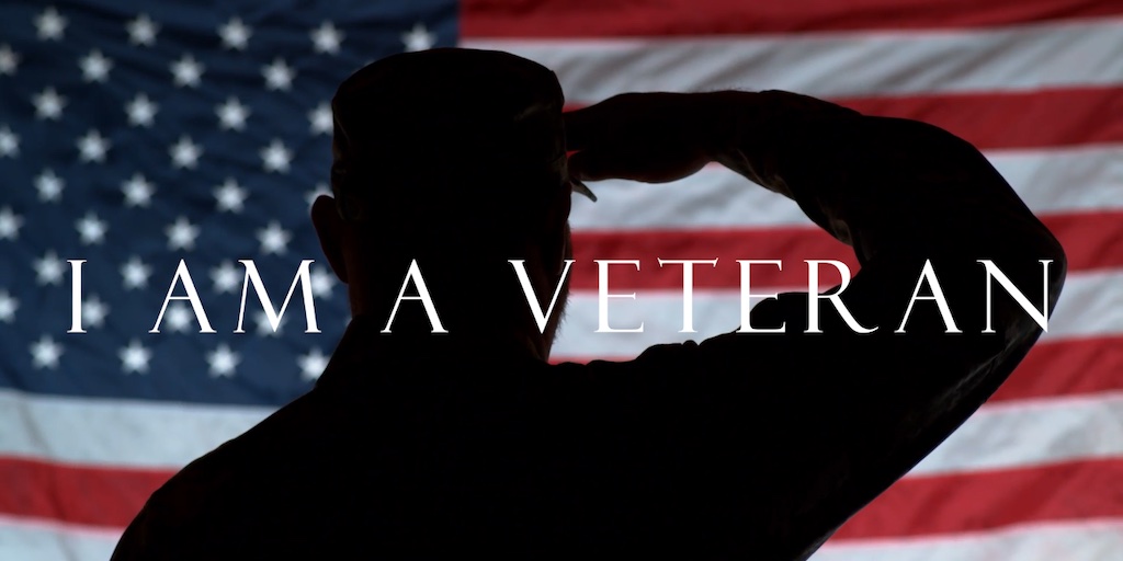 Soldier saluting with flag in the background