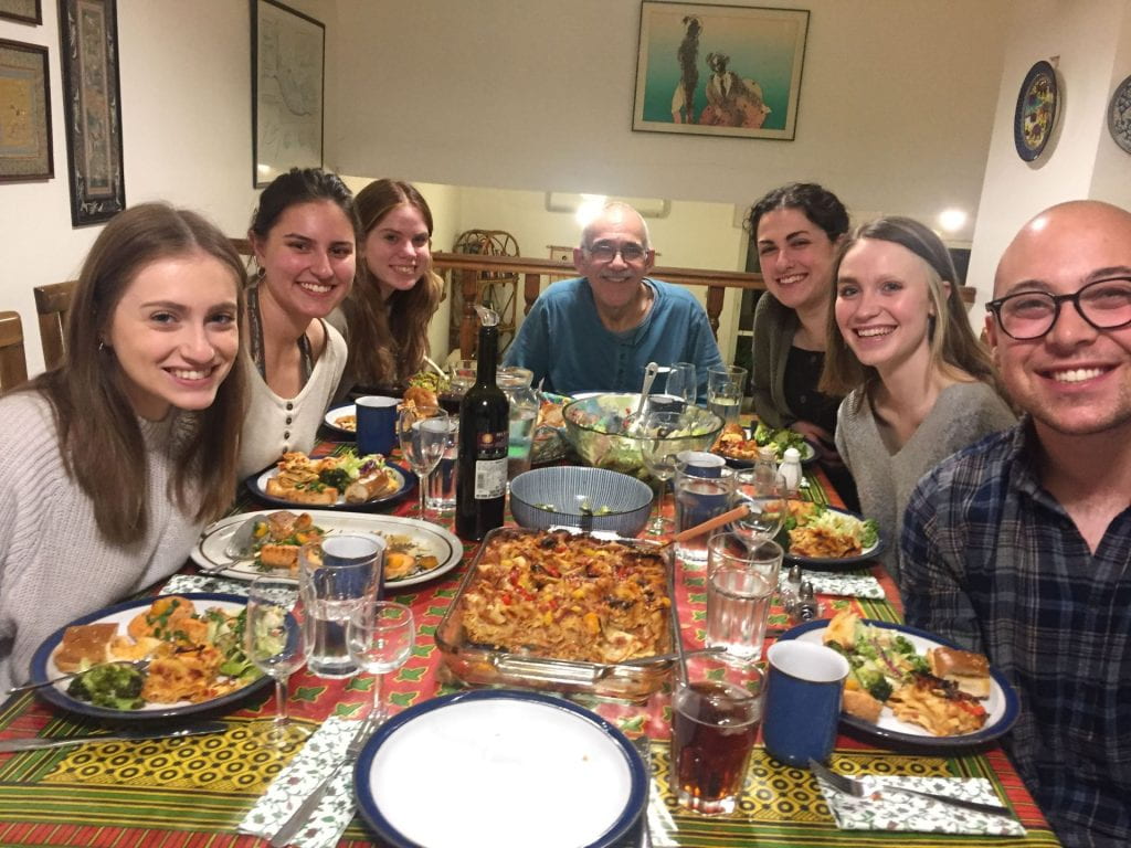 Students studying abroad at Hebrew University in Jerusalem sit around a table for dinner.