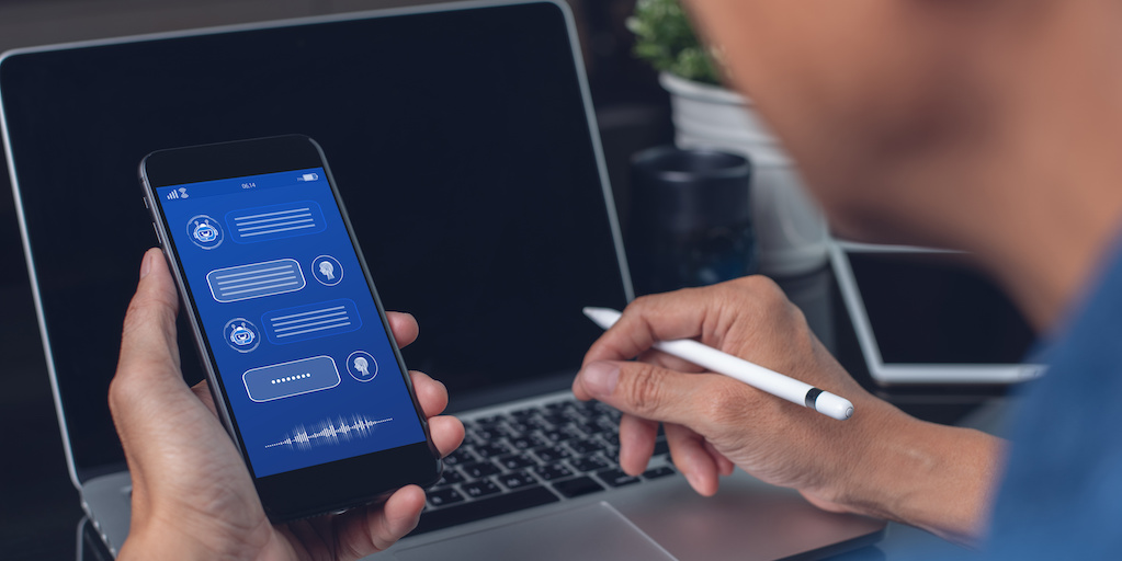 Person using smart phone and chatbot