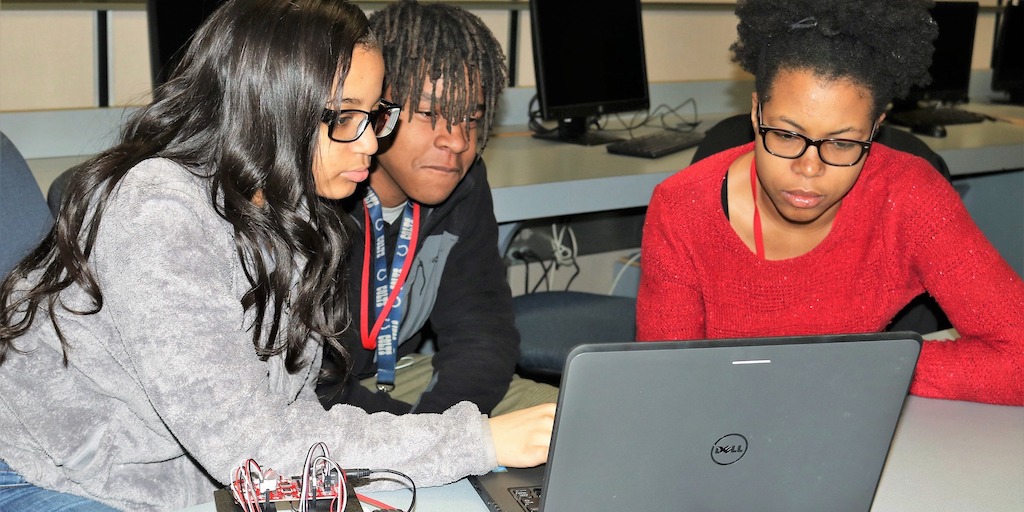 Group of students working at a computer