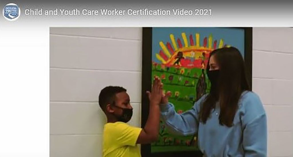 Student high-fives teacher