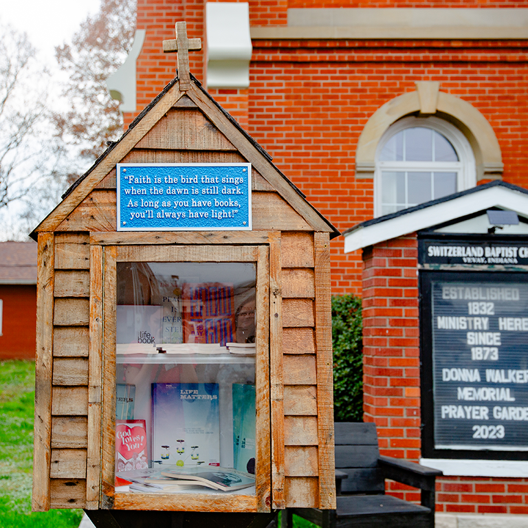A little free library welcomes passersby outside a church in Vevay, Indiana.