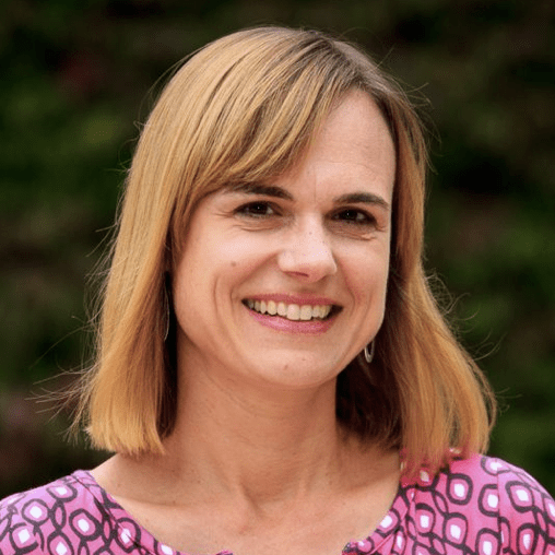 Headshot of Katrin Völkner, a middle-aged white woman with a honey-blonde, long-bob haircut, smiling into the camera